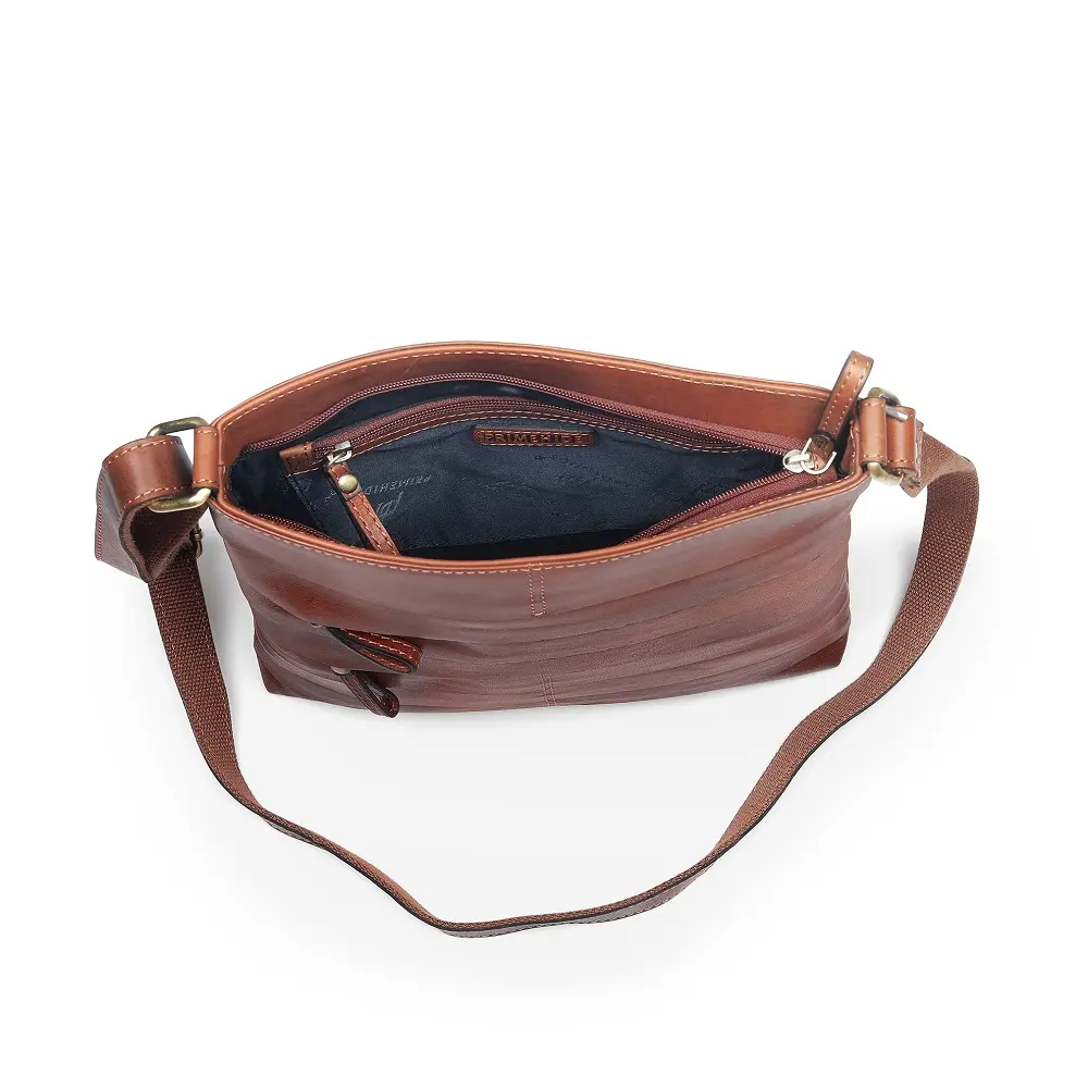 Leather Crossbody Bag Ridgeback-3 Top-down view of the open Boho Layered Leather Bag - Ridgeback, showing the zipped main compartment and inner branding for a touch of elegance.