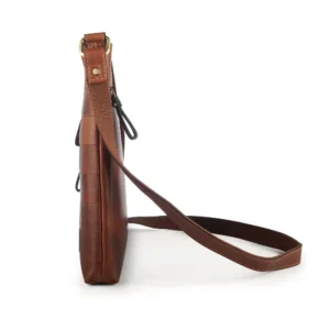 Leather Crossbody Bag Ridgeback-5 Side profile of the Boho Layered Leather Bag - Ridgeback, highlighting its slim yet spacious silhouette and adjustable strap for versatile use.