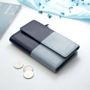 Clara Flapover Purse in navy and blue, closed and placed on a table, highlighting its modern and stylish appearance.