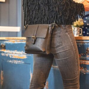 1567 Rica Black Crossbody Bag with buckle (2) A smart casual woman with a black crossbody bag
