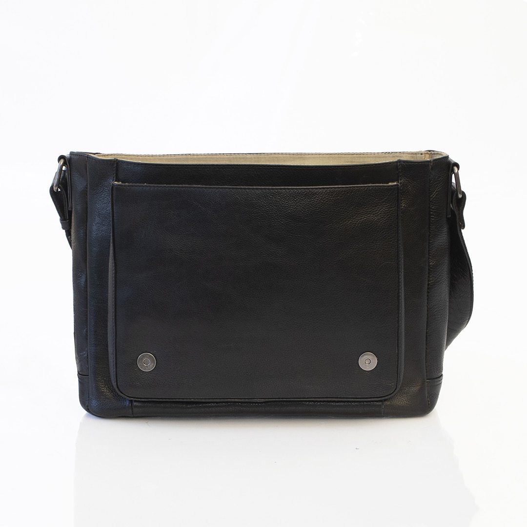 Orion Messenger Bag - 2004BLK-07 black leather messenger bag is open to show a front slip pocket and a magnetic button closure for the top flap.