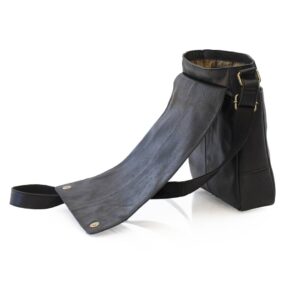 side view of a small black messenger bag. the bag is open to show a flap over closure with magnetic buttons