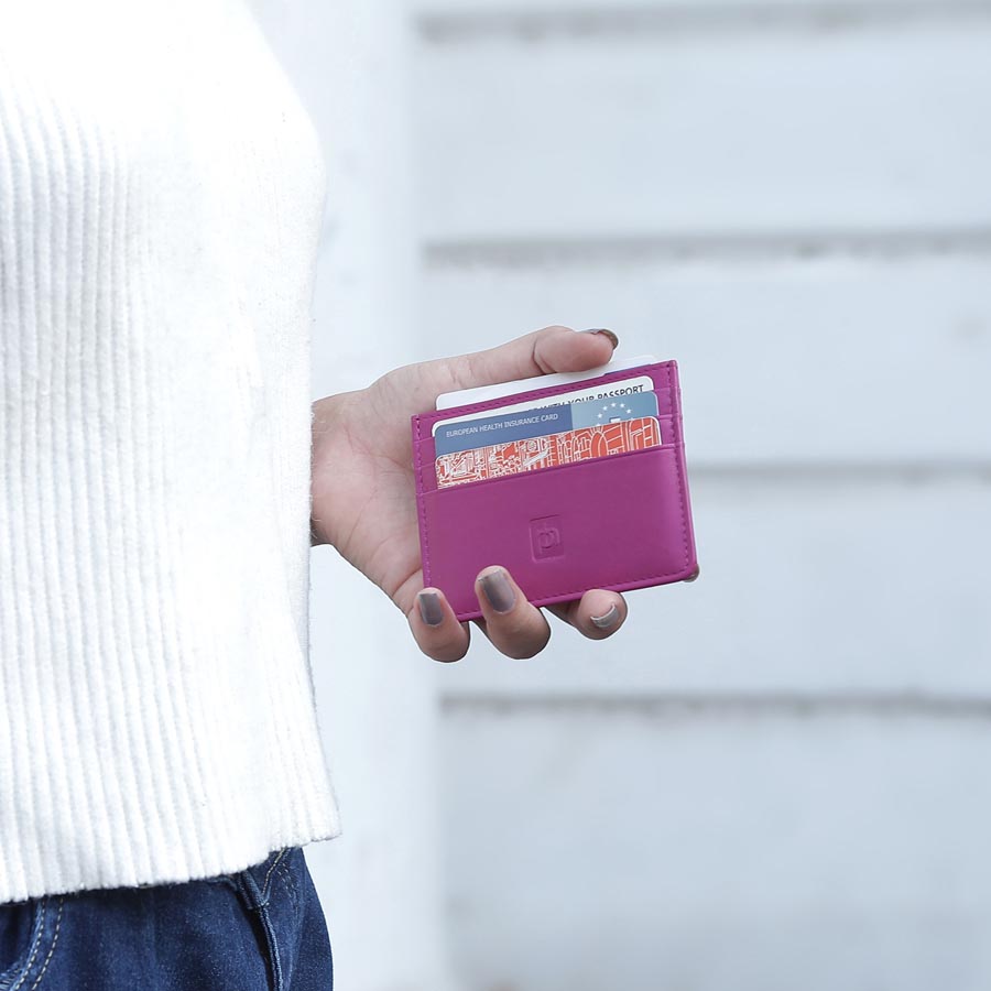 Fuchsia Personalised Leather Card Holder with RFID 04 Person holding slim leather card holder with multiple cards inserted