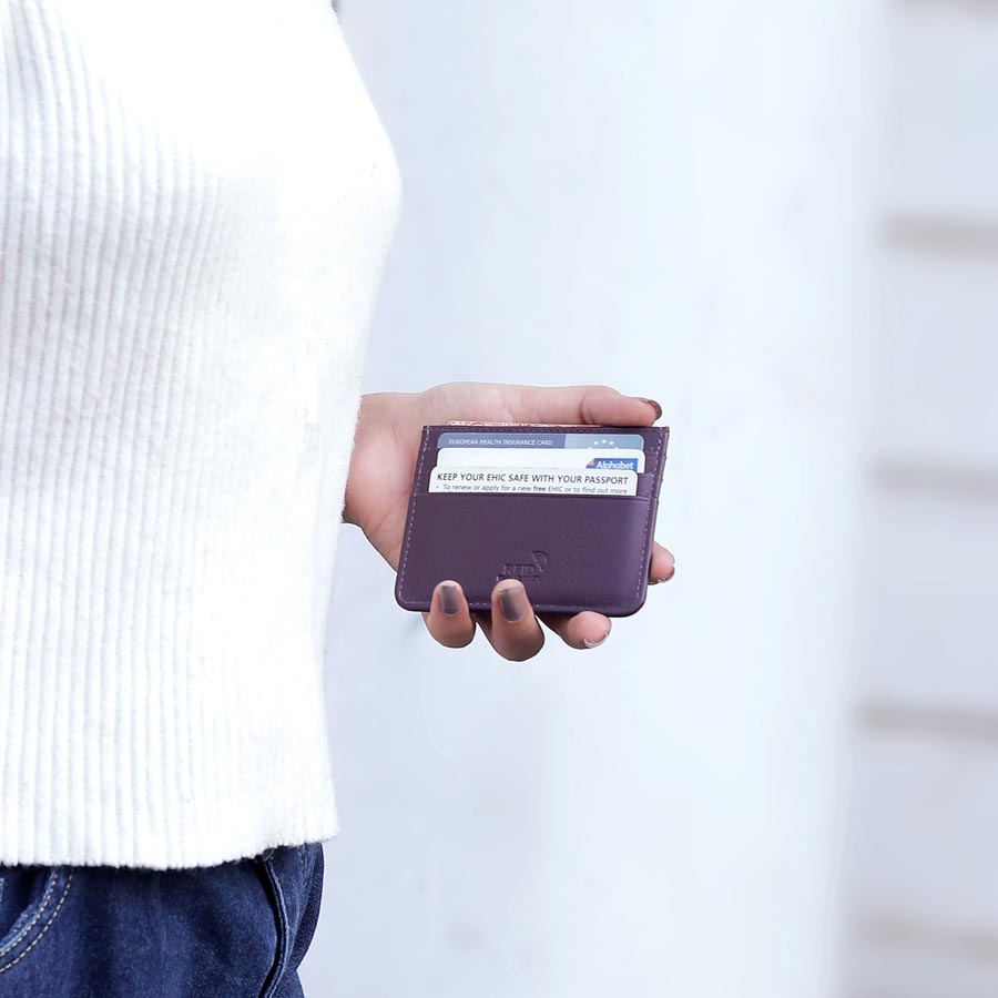 Purple Personalised Leather Card Holder with RFID 01 Person holding a purple leather card holder filled with cards