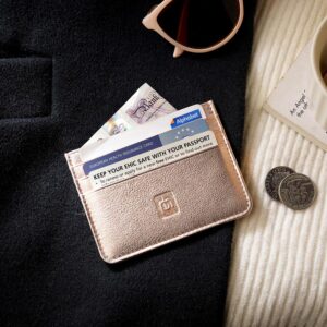 Rose Gold Personalised Leather Card Holder with RFID 02 Rose gold leather card holder placed on a black coat with sunglasses, coffee, coins, and an EHIC card visible.