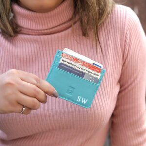 Turquoise Personalised Leather Card Holder with RFID 01 Woman in pink jumper holding turquoise personalised leather card holder with initials