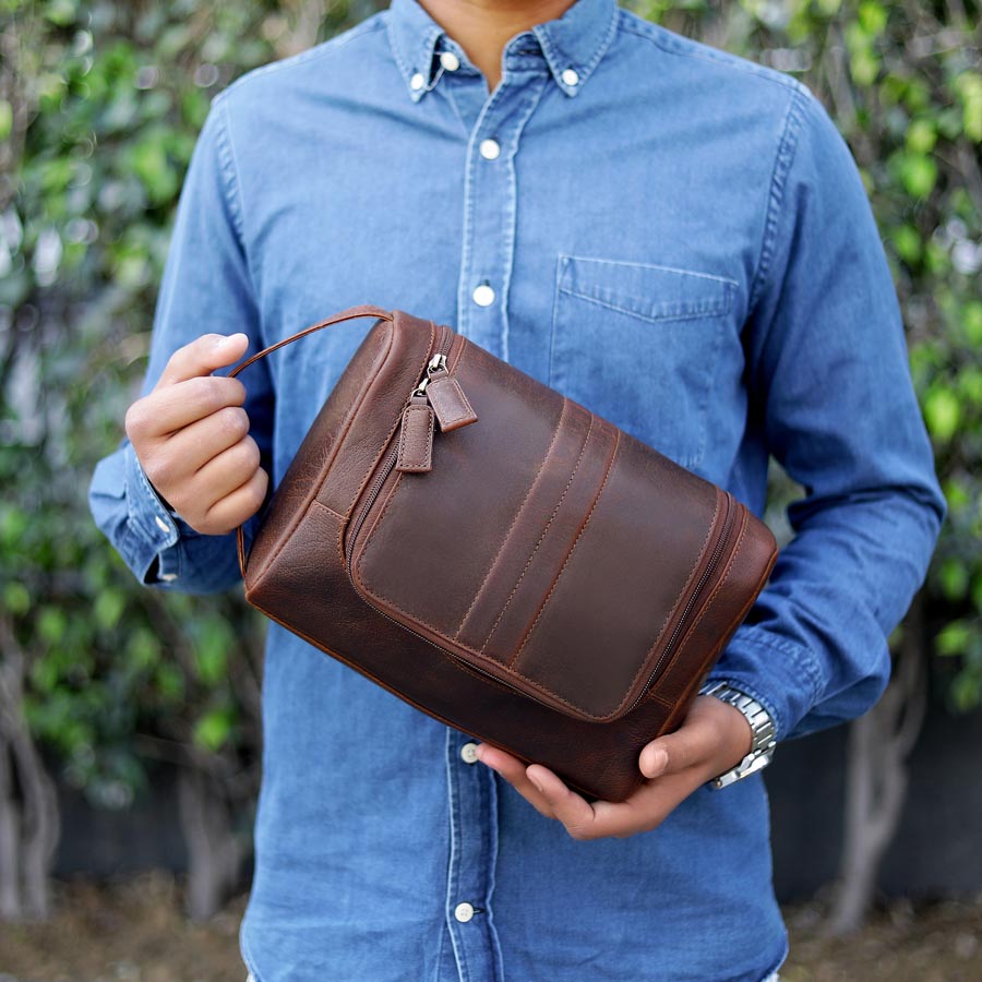 Man holding personalised leather wash bag – ideal luxury gift for men who travel, perfect for Father’s Day.