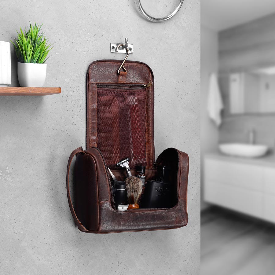 Men’s leather hanging wash bag in bathroom, perfect grooming gift for husbands, dads or frequent travellers.